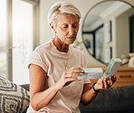 Senior woman, medicine pills and reading instructions on healthcare, medical wellness and pharmacy tablet box in house living room. Thinking retirement elderly with insurance drugs product in Sweden