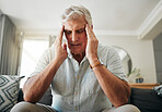 Senior man with headache, stress or anxiety about retirement, financial problem or house mortgage in his living room. Sick elderly man with migraine pain or mental health risk and frustrated on sofa