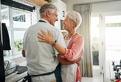 Buy stock photo Cooking dance, dinner and senior couple dancing with smile while making lunch in the kitchen of house. Happy elderly man and woman doing jazz movement with love to music while preparing food in home