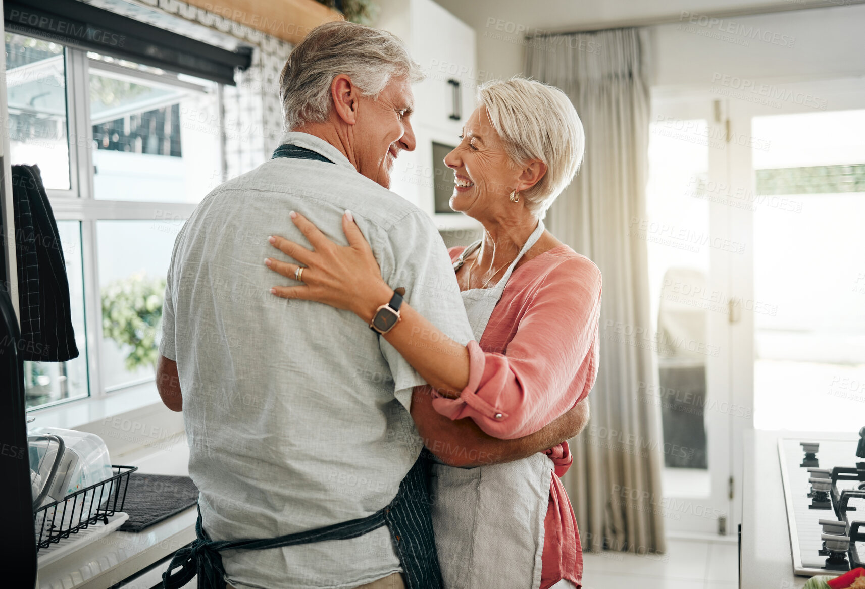 Buy stock photo Cooking dance, dinner and senior couple dancing with smile while making lunch in the kitchen of house. Happy elderly man and woman doing jazz movement with love to music while preparing food in home