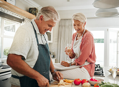 Buy stock photo Love, food and elderly couple is cooking healthy dinner together in the kitchen enjoying wine and bonding at home. Smile, diet and vegan old man helping married senior woman and cutting vegetables