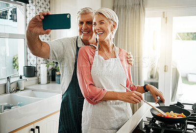 Buy stock photo Old couple, phone selfie and cooking in kitchen, delicious meal and food in home. Love, smile and happy elderly retired romantic man and woman cook breakfast in the morning and take picture together.