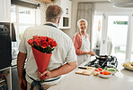 Roses, gift and senior couple love flowers to celebrate their marriage anniversary in a romantic way at home. Romance, happy and old man giving wife a bouquet for a happy birthday surprise present