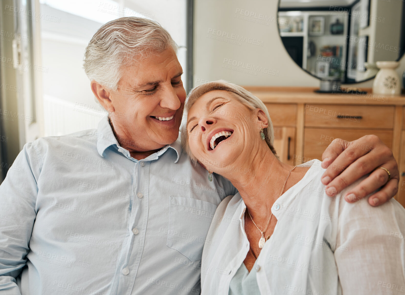 Buy stock photo Love, happy family and senior couple laugh and relax in living room, bond and share funny joke in their home. Retirement, humour and affection by sweet elderly man and woman hug, enjoy time together