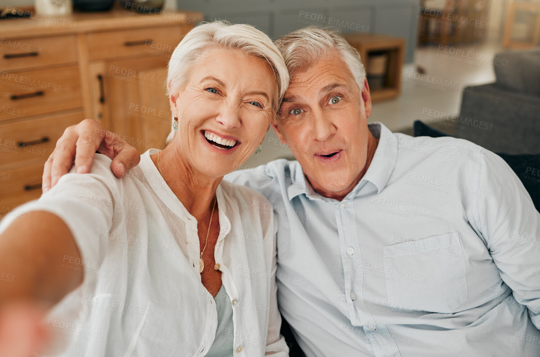 Buy stock photo Happy old couple, selfie and hug in living room spending quality time together. Love picture, retirement and portrait of elderly, romantic man and woman at home laughing, bonding or care with smile.
