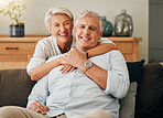 Happy senior couple on sofa hug, happy and smile in living room for retirement, love and happiness at home. Portrait, retired and together elderly man and woman care, support and joy on lounge couch