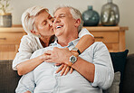 Love, retirement and kiss with couple on sofa for support, trust and happy together. Relax, smile and lifestyle with old man and senior woman in living room together for embrace, marriage and hug 