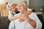 Elderly, couple and happy hug of woman and man with quality time on a house sofa together. Happiness and smile of senior people embracing with love during retirement on a home living room couch