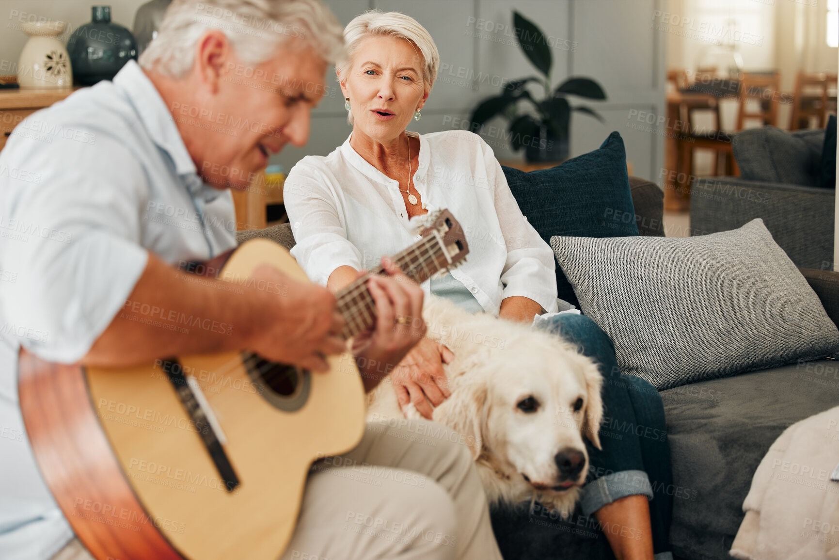 Buy stock photo Retirement, relax and guitar with couple on sofa with dog together for music, happy or love. Peace, smile and marriage with elderly woman listening to old man and instrument with pet in living room