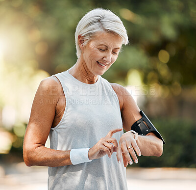 Buy stock photo Senior woman, fitness and watch of running time in health and wellness for cardio exercise in nature. Active elderly female runner checking smartwatch to monitor training results in sports workout