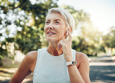 Buy stock photo Senior woman, fitness and music earphones for workout, training or exercise in nature park or Sweden garden. Thinking mature person listening to podcast, healthcare radio or wellness motivation audio