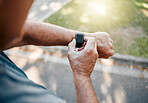 Man, street and running with smartwatch for heart reading, health and fitness on break. Runner, watch and road check time, speed or distance on workout, exercise or training outside for body wellness