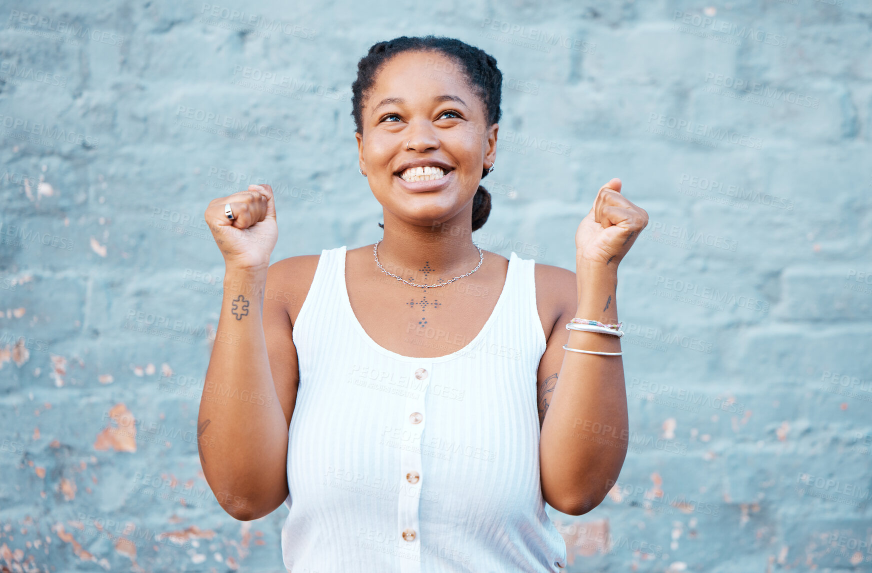 Buy stock photo Happy black woman, smile and winner in success for victory. deal or prize against a wall background. Excited African female smiling in celebration happiness for winning achievement with arms raised