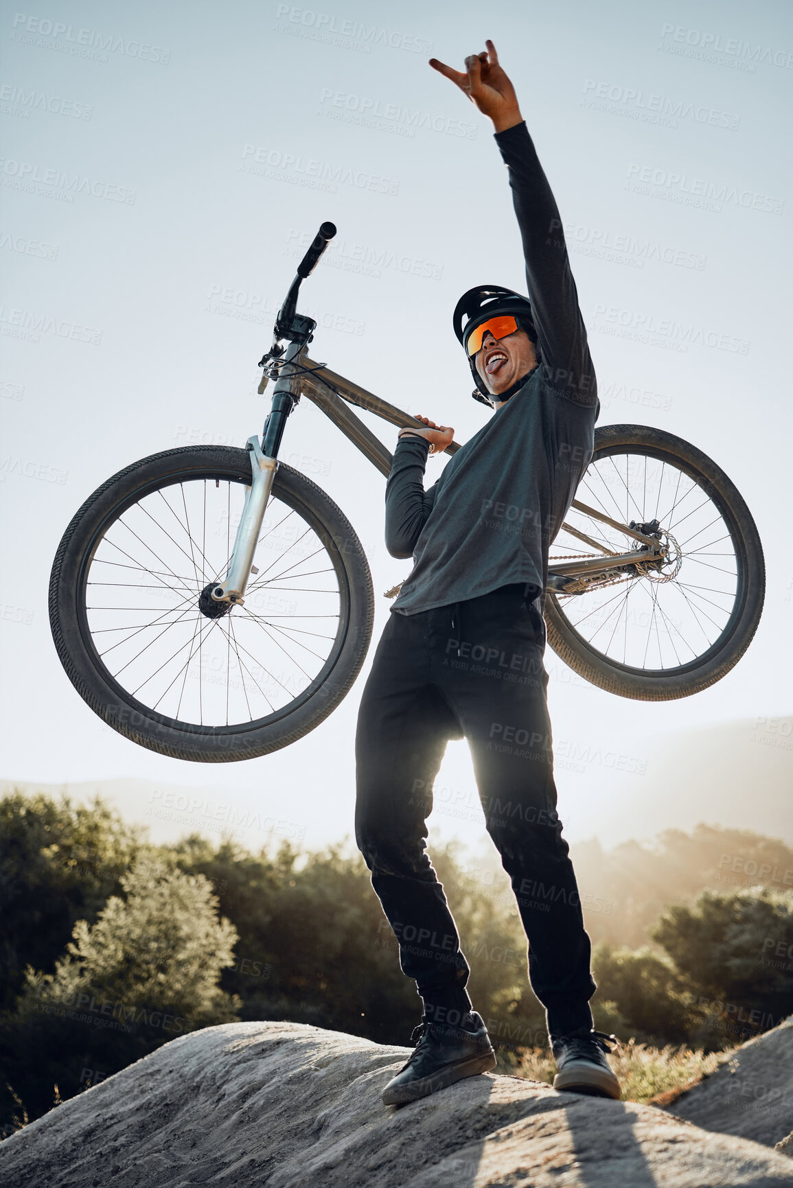 Buy stock photo Man, mountain and bike celebrate, happy and excited after reaching summit in training. Cyclist, bicycle and rock in nature, lift hand and success in sport adventure for fitness on hill in Argentina