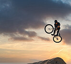 Mountain bike, jump and sport with mockup of a man athlete with energy and speed in nature. Healthy sports person with speed jumping and cycling with his bicycle at sunset on mountains with mock up