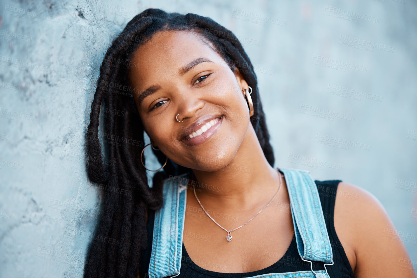 Buy stock photo Black woman, face and freedom with a strong, independent or free female standing outdoor with a smile. Portrait of gen z with a millennial youth outside against a blue wall background