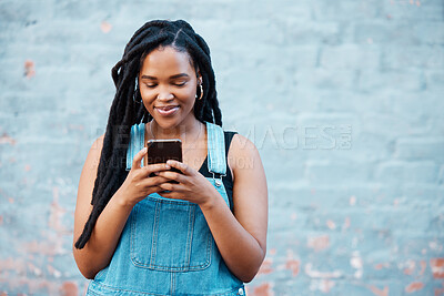 Buy stock photo Happy black woman typing on smartphone on social media marketing, advertising or mobile app on blue wall background mockup. Gen z teenager with cellphone networking, online chat or check notification