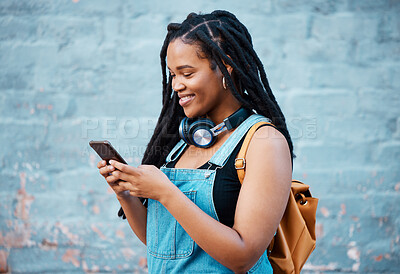 Buy stock photo Black woman, smile and phone of a student from Jamaica with technology and headphones. Happy, urban and gen z person using 5g internet, web and social media app scroll while texting with happiness