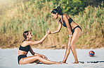 Volleyball teamwork, women support on beach sports in Brazil summer fitness and help in healthy lifestyle. Young athletes shake hands, friends training together in bikini and strong helping girl