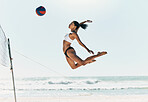 Sports woman jump at volleyball beach summer outdoor competition game on ocean or sea sand playing to win. Healthy, fitness and training agile girl or young athlete ready hit ball over net in match