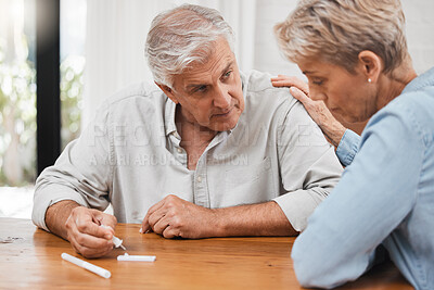 Buy stock photo Covid, test and stress with a senior couple using a rapid antigen kit at home with anxiety about the results. Fear, worry and healthcare with an elderly man and woman worried about their health