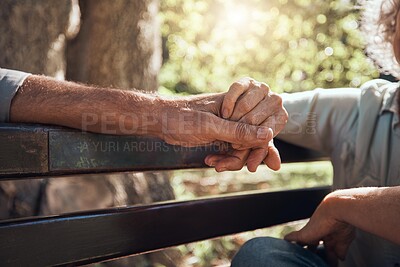 Buy stock photo Support, love and helping hand holding of elderly people showing solidarity and community in a park. Senior man and woman hands together in retirement on a park bench outdoor with hope and trust