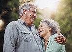 Senior couple, outdoor and laughing in nature while active on hiking adventure or outside for a walk enjoying love and fresh air. Happy old man and woman in healthy retirement relationship in forest