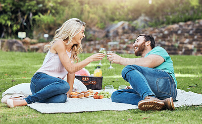 Buy stock photo Couple, picnic and park of a man and woman cheers to happiness and love in nature. Happy people together with a smile enjoying alcohol and food laughing with quality time for an anniversary outdoor
