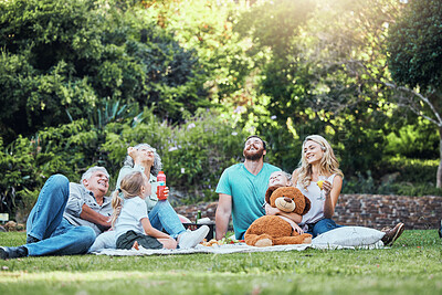 Buy stock photo Happy, nature and big family on an outdoor picnic together in a green garden blowing bubbles. Happiness, elderly grandparents and parents relaxing, bonding and playing with children in a outside park
