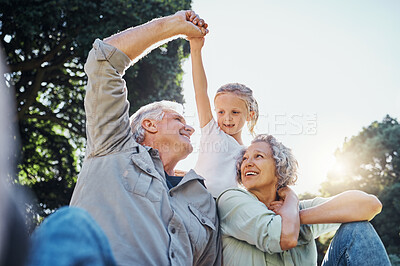 Buy stock photo Grandparents playing together with a girl in the park in the morning. Family, love and grandchild bonding with grandmother and grandmother in a garden. Child holding hands with senior couple outside