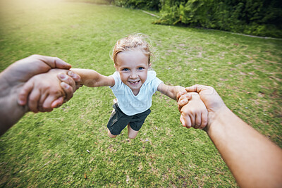 Buy stock photo Hands, park smile and girl swinging with support from family in green nature together in summer. Portrait of young child playing, being funny and excited in a circle on the grass in a green garden