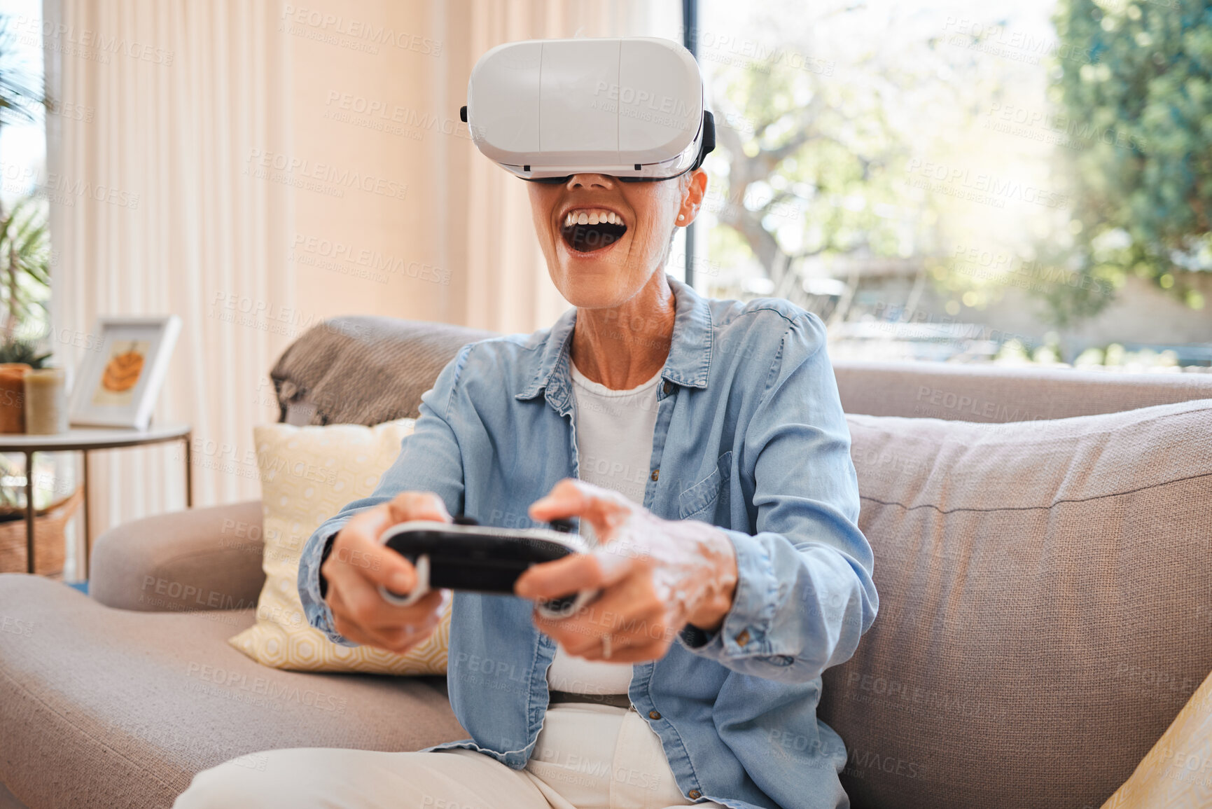 Buy stock photo VR, metaverse and 3d gaming with a woman playing a video game on a sofa in the living room of her home. Virtual reality, esports and technology with a female gamer enjoying an online experience