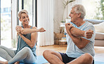 Stretching, home fitness and senior couple training together on the living room floor in the house. Happy elderly man and woman doing yoga, pilates exercise and cardio for body health in the lounge