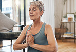 Senior woman, yoga and meditation at home for exercise, wellness and health during zen practice for peace, balance and mindfulness. Fitness, retirement and fit old lady in prayer position to relax 