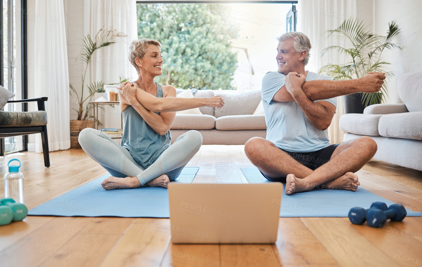 Buy stock photo Stretching, happy morning and senior couple training with online workout in the living room of their house. Elderly man and woman doing warm up before fitness exercise with internet yoga on tech 