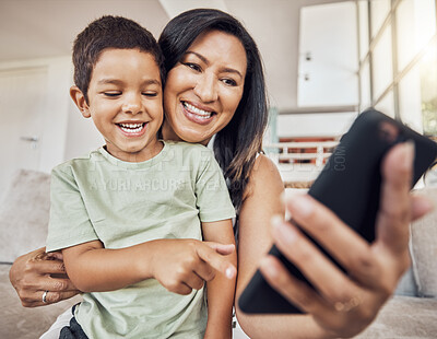 Buy stock photo Happy mother and child with smartphone on sofa for games app, funny social media post or elearning website. Kid with mom on couch and cellphone education, video call or watch comedy video online