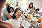 Big family selfie while eating food or lunch together in their home dining room table with a portrait smile. Happy Puerto Rico parents, mother and father with children for digital holiday memory
