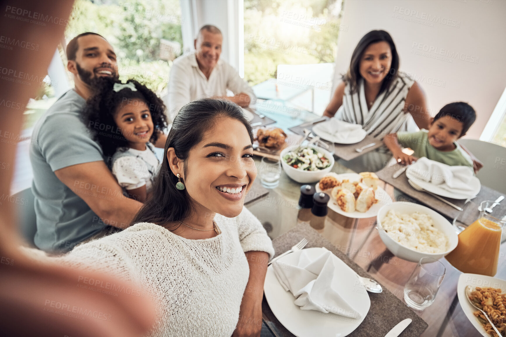 Buy stock photo Big family selfie while eating food or lunch together in their home dining room table with a portrait smile. Happy Puerto Rico parents, mother and father with children for digital holiday memory