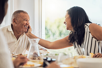 Buy stock photo Couple, love and food with a woman and man eating during a family lunch or dinner in their home together. Happy, smile and retirement with a married husband and wife enjoying a meal in a dining room