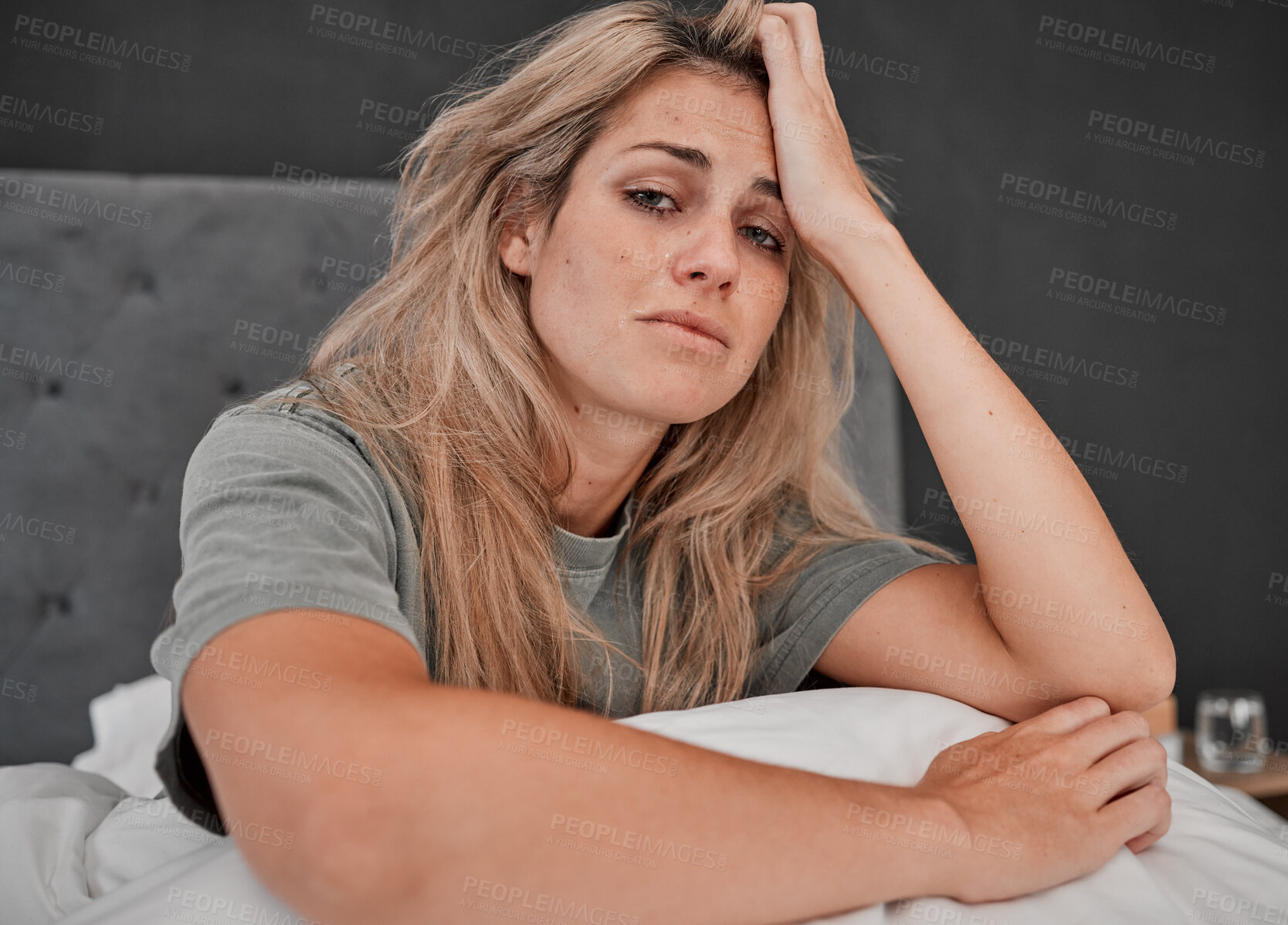Buy stock photo Depression, tired and portrait of a sick woman sitting on the bed in her bedroom at home. Anxiety, mental health problem and exhausted girl crying with insomnia, headache and burnout at her house.