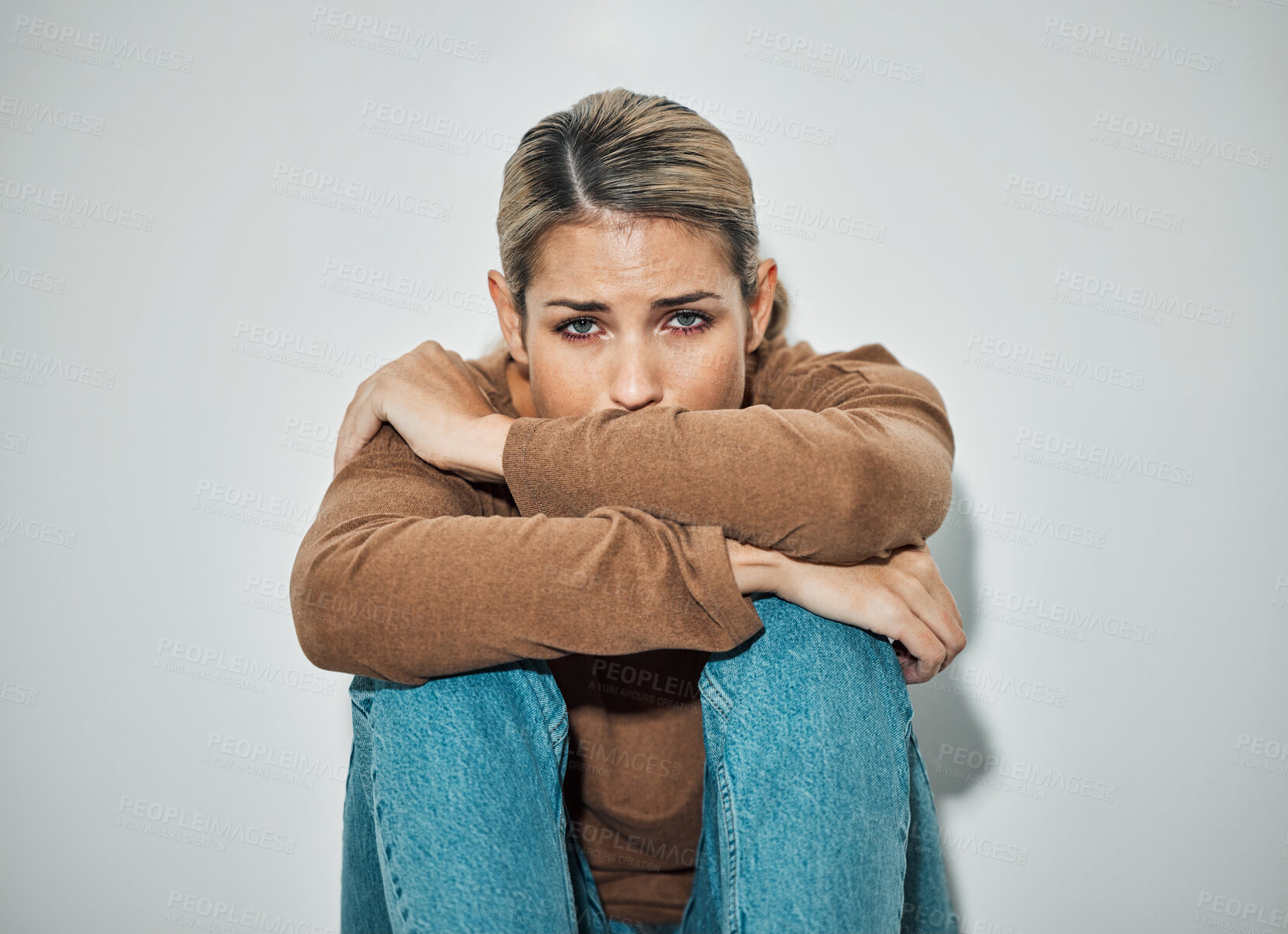 Buy stock photo Woman, anxiety and depression while sitting against a wall with stress, sadness and feeling unhappy or sad. Serious California woman feeling depressed, anxious and worried while lonely and scared