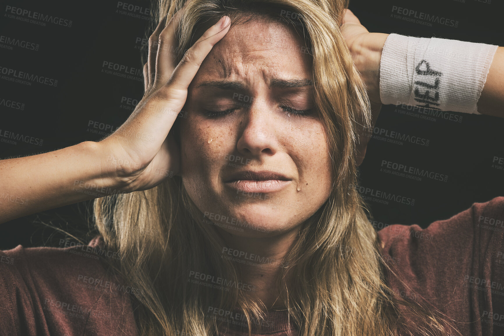 Buy stock photo Mental health, depressed woman and help for drug addiction, suicide thoughts or schizophrenia and crying in dark studio. Bandage, paranoid and rehabilitation for crazy female addict with depression