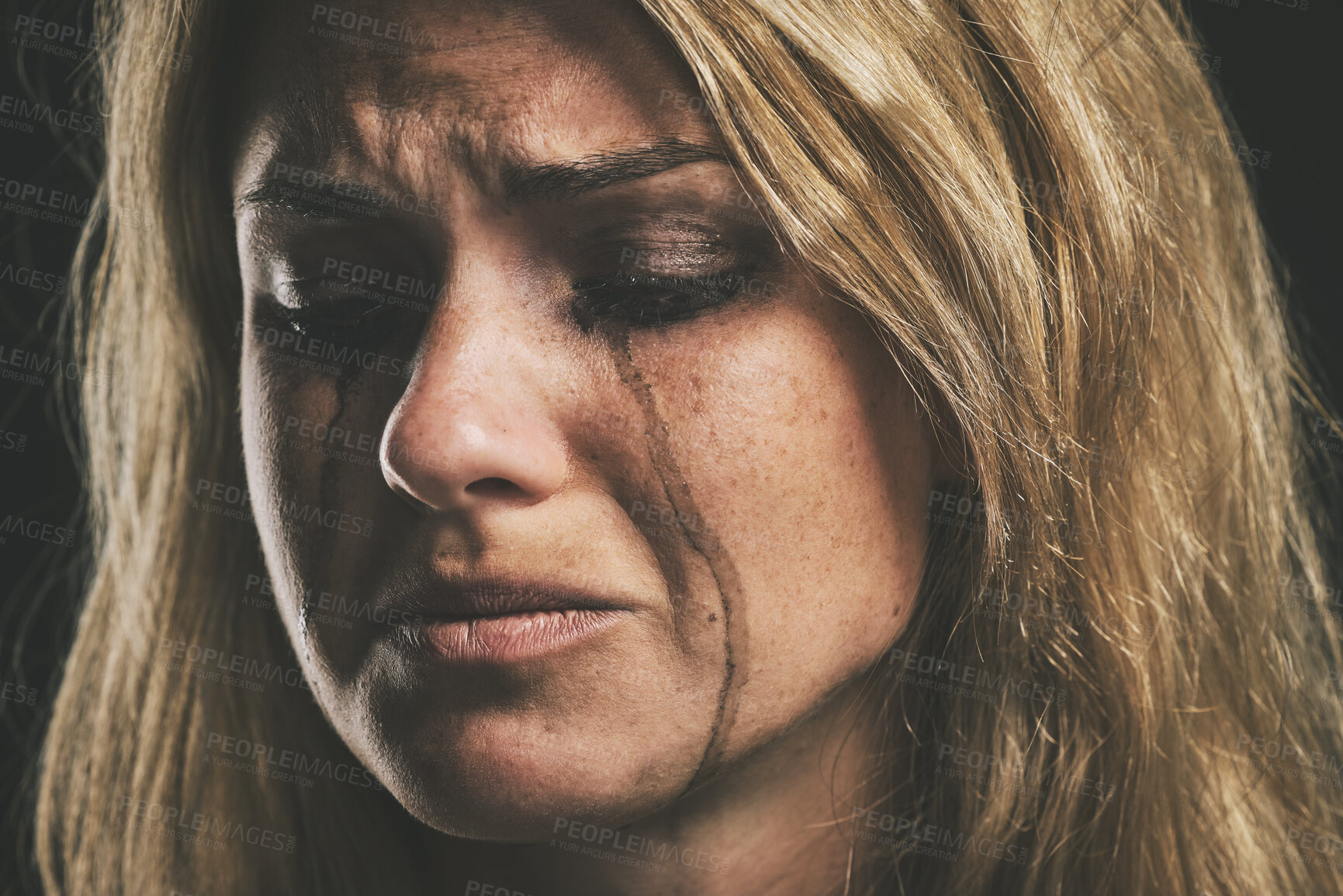 Buy stock photo Sad, depression and woman crying on dark studio background for mental health or psychology awareness. Young, depressed mental illness person tears and smudge makeup for anxiety, violence or fear
