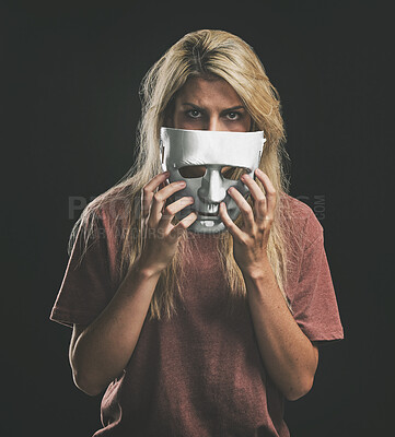 Sad portrait and woman with bipolar mask to hide depression struggle with mockup in studio. Depressed girl hiding identity, emotions and mental health disorder with theatre face disguise.