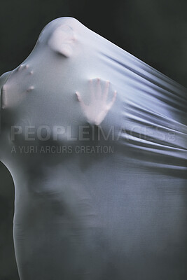 Buy stock photo Psychology, fabric and horror with the hands of a woman trapped in textile in studio on a dark background. Curtain, help and dream with a female ghost draped in white material while looking scary