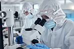 PPE, covid and DNA scientist with microscope research for science innovation, investigation and development in a test laboratory. Biotechnology people with analysis or studying medical sample in lab