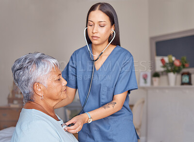 Elderly patient, nursing and nurse with a stethoscope listening to heartbeat during a health consultation. Healthcare professional, senior woman and medical checkup in her room at the retirement home