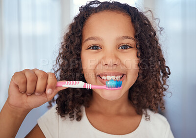 Buy stock photo Girl, brush and smile with teeth for dental, care and clean hygiene in fresh oral healthcare at home. Portrait of a happy female child, face and toothbrush smiling in bathroom for morning routine