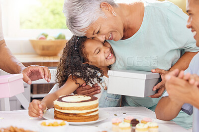 Buy stock photo Hug, happy and gift giving of a grandmother and girl with birthday cake at a party celebration. Happiness of people at a children event to celebrate with food, family and friends smile at a home