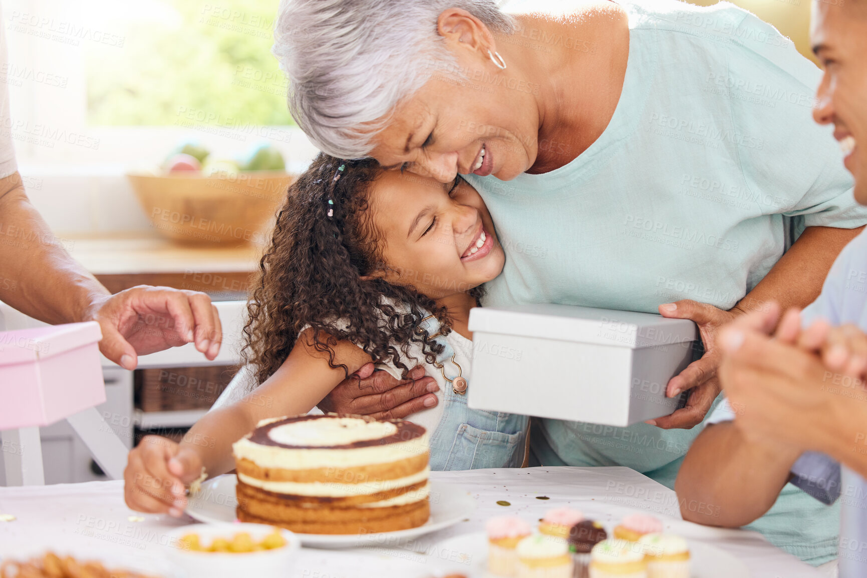 Buy stock photo Hug, happy and gift giving of a grandmother and girl with birthday cake at a party celebration. Happiness of people at a children event to celebrate with food, family and friends smile at a home
